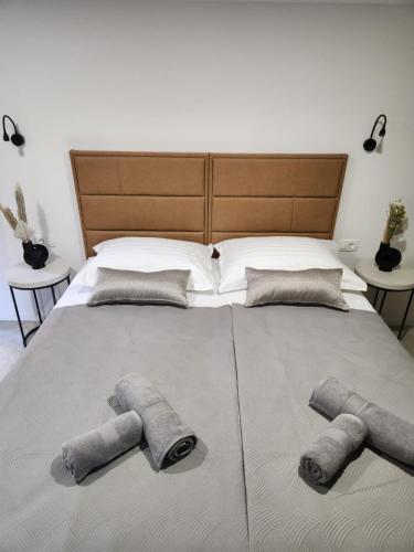 a large bed with three pillows on top of it at Rio Luxury Rooms in Split
