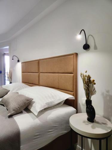 a bedroom with a bed with a vase on a table at Rio Luxury Rooms in Split