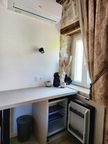 a kitchen with a white counter top and a window at Rio Luxury Rooms in Split