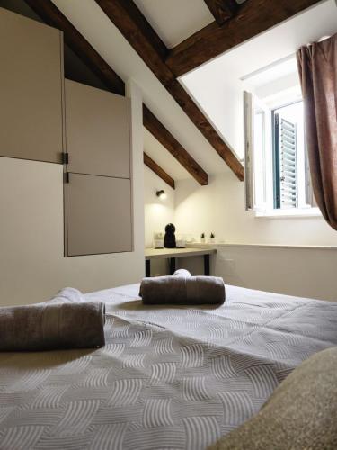 a bedroom with a large bed and a window at Rio Luxury Rooms in Split