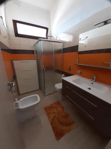 a bathroom with a sink and a toilet and a shower at White House in Tre Fontane
