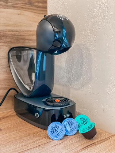 a coffee maker sitting on top of a table at Old Town Apartment in Marijampolė