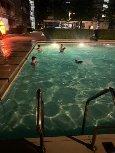 a group of people in a swimming pool at night at MISR Silence in Manila