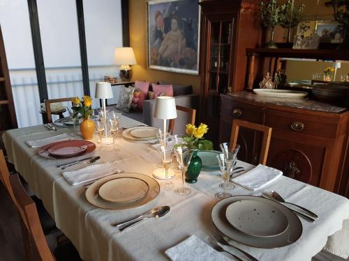 a table with plates and napkins on top of it at La Stanza dei Sogni in Saluzzo