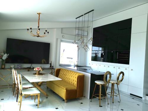 a kitchen with a couch and a table and chairs at Luxury Penthouse with Large Terrace & Panoramic Old Town View in Vilnius