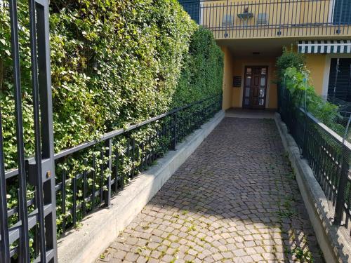 a walkway leading to a building with a gate at La Stanza dei Sogni in Saluzzo