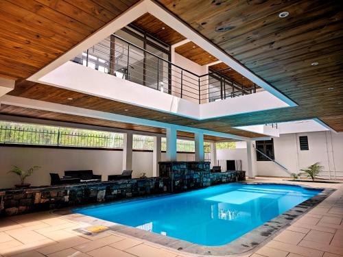 an indoor swimming pool with a large open ceiling at Villa le Dodo - GBH in Grand Baie