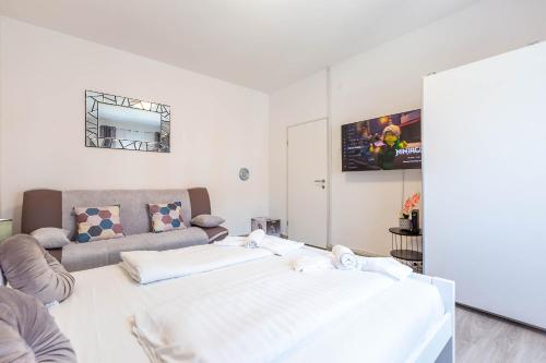a living room with a bed and a couch at Viktorija 1BR Apartment in Zadar