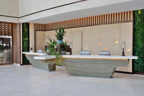 a lobby with two large tubs in a building at JW Marriott Hotel Riyadh in Riyadh