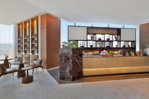 a kitchen with a counter and a table and chairs at JW Marriott Hotel Riyadh in Riyadh