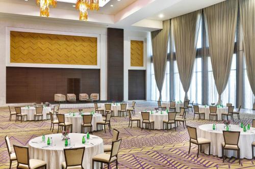 a banquet hall with white tables and chairs at JW Marriott Hotel Riyadh in Riyadh