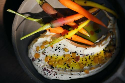 a bowl of food with carrots and other vegetables on it at JW Marriott Hotel Riyadh in Riyadh