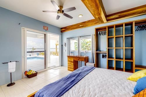 a bedroom with a bed and a ceiling fan at The Lor-E-Lei House in San Pedro