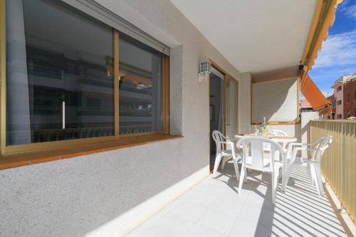 a patio with a table and chairs on a balcony at UHC MIRAMAR NAUTIC in Salou