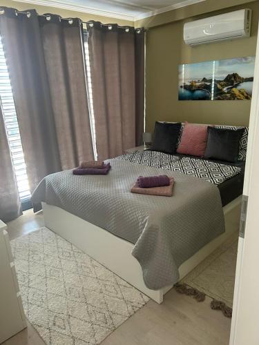 a bedroom with a bed with two pillows on it at Club Panorama Lake View Apartment in Alsóörs