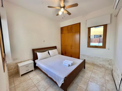 a bedroom with a bed and a ceiling fan at Lovely Pool Villa in Pyla in Pyla