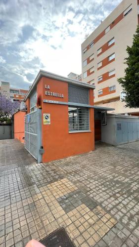 an orange building in front of a building at Work and Rest Away From Home in Paterna