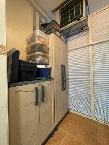 a kitchen with a cabinet with a tv on it at Work and Rest Away From Home in Paterna