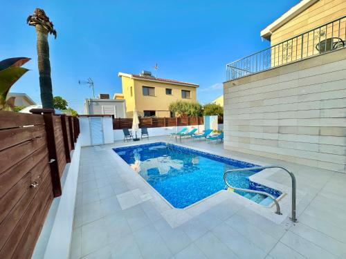 a swimming pool in the middle of a house at Lovely Pool Villa in Pyla in Pyla
