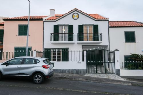 a small car parked in front of a house at Kayak Azores in Ponta Delgada