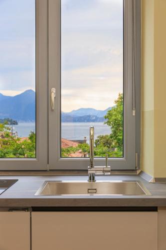 a kitchen with a sink and a window at Leopoldo in Baveno