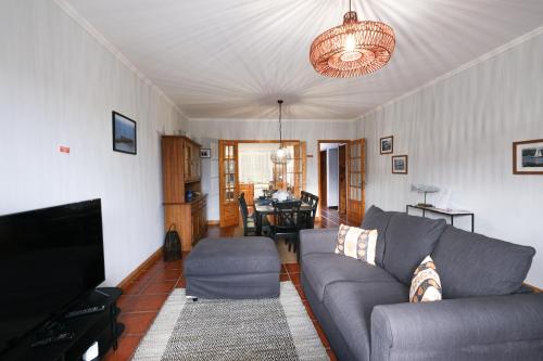 a living room with a couch and a tv at Kayak Azores in Ponta Delgada