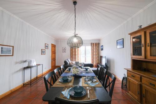 a dining room with a table and chairs at Kayak Azores in Ponta Delgada