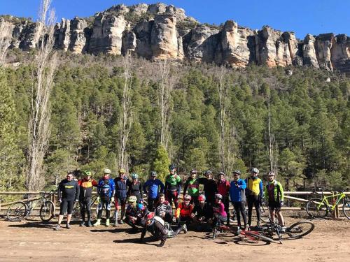 a group of people posing for a picture in front of a mountain at Hotel Río Escabas, Serranía de Cuenca in Cañamares