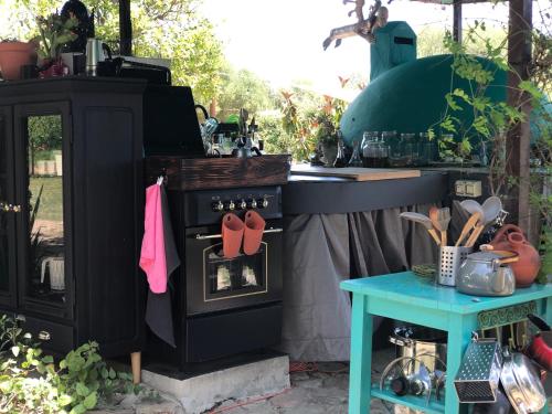 an outdoor kitchen with a stove with flip flops on it at Eco Spirit in Tarifa