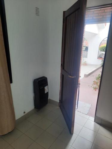an open door to a room with a small refrigerator at Casa Cecilia tiene wifi in General Alvarado