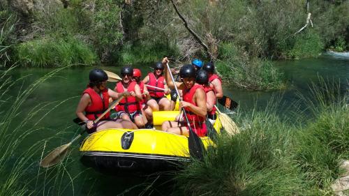 a group of people in a raft on a river at Hotel Río Escabas, Serranía de Cuenca in Cañamares