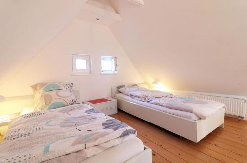 two beds in a room with a attic at Ferienhaus- die KATE in Barth am Bodden in Barth
