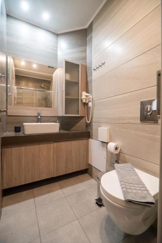 a bathroom with a toilet and a sink at Lidra Rooms in Chania