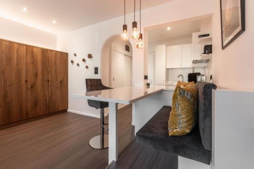 a kitchen with a counter and a table in a room at Gran Tubla Apartments in Ortisei