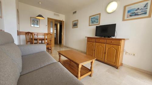 a living room with a couch and a flat screen tv at Gemelos 22-Fincas Benidorm in Benidorm