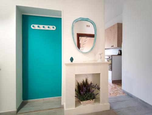 a blue door in a living room with a mirror at Sole Paola in Anzio