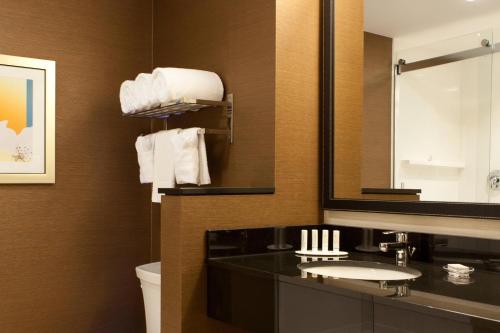 a bathroom with a sink and a mirror at Fairfield Inn & Suites by Marriott Lethbridge in Lethbridge