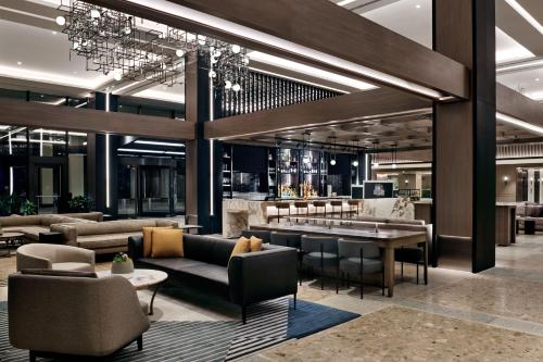 a lobby of a hotel with couches and a bar at Sheraton Centre Toronto Hotel in Toronto