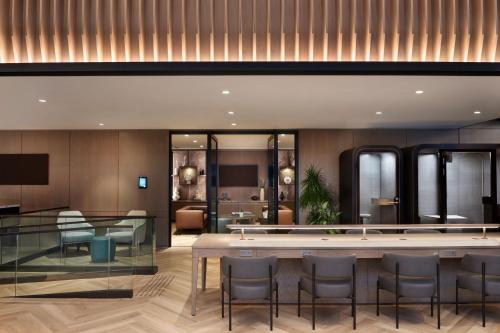 a lobby of a hotel with a table and chairs at Sheraton Centre Toronto Hotel in Toronto