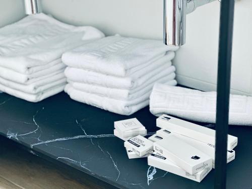 a shelf with white towels on top of a table at Apartamentos Noja Playa in Noja