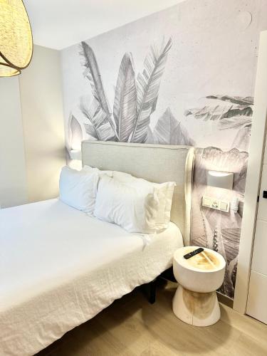 a bedroom with a bed with a toilet and a mural at Apartamentos Noja Playa in Noja
