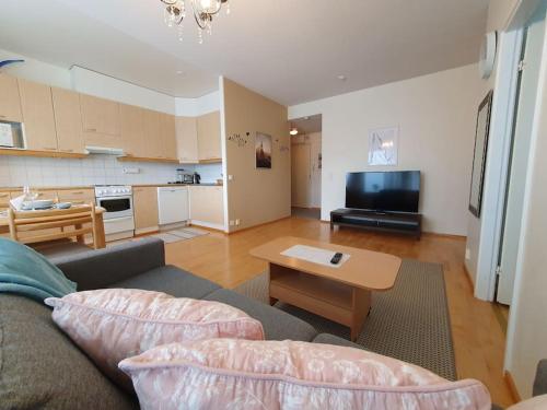 a living room with a couch and a table at Rovaniemi Ruokasenkatu apt - Wi-Fi - Sauna - Free Parking in Rovaniemi
