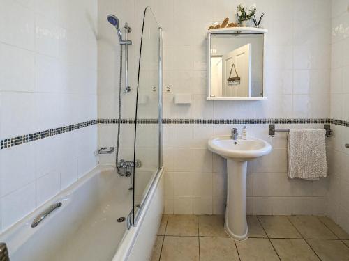 a bathroom with a sink and a shower and a bath tub at The Coach House - Uk38044 in Beetham
