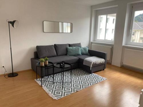a living room with a couch and a table at FarawayHomes Studio Leoben #A11 in Leoben