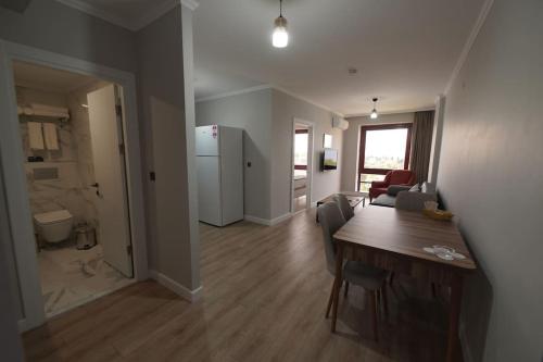 a living room with a dining table and a kitchen at Royal Homes 401 in Antalya