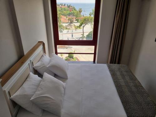 a bedroom with a bed with a large window at Royal Homes 401 in Antalya