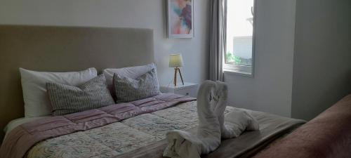 a bedroom with a bed with boots on it at Light Blue Apartment in Aveiro