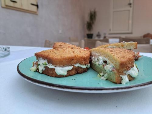 two sandwiches on a blue plate on a table at Hotel Restoran Humsko in Trebinje