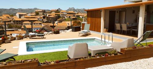 a backyard with a swimming pool and a house at Pitões NatureHouse in Pitões das Júnias