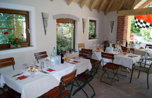 a dining room with white tables and chairs at Gasthof zur Post in Soding